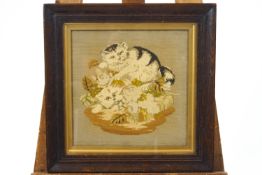 A late 19th century framed Berlin wool work of two cats in foliage,