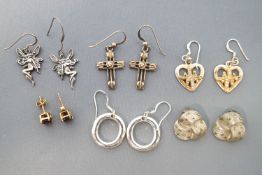 A collection of six pair of sterling silver earrings of variable designs.