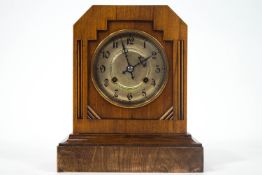 An early 20th century mantel clock in the Art Deco style enclosing a silvered dial,