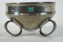 An Arts and Crafts style pewter bowl with inset turquoise coloured cabouchons set to the rim,