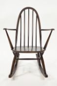 An Ercol elm and bentwood stick back rocking chair,