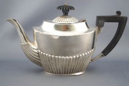 A silver bachelor's tea pot of usual oval ribbed form with domed lid on a concave top