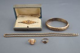 A collection of jewellery to include: A stamped 9ct bar brooch; A hallmarked 9ct gold signet ring;