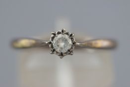 A yellow metal ring set with a round brilliant cut diamond of approximately 0.25cts.