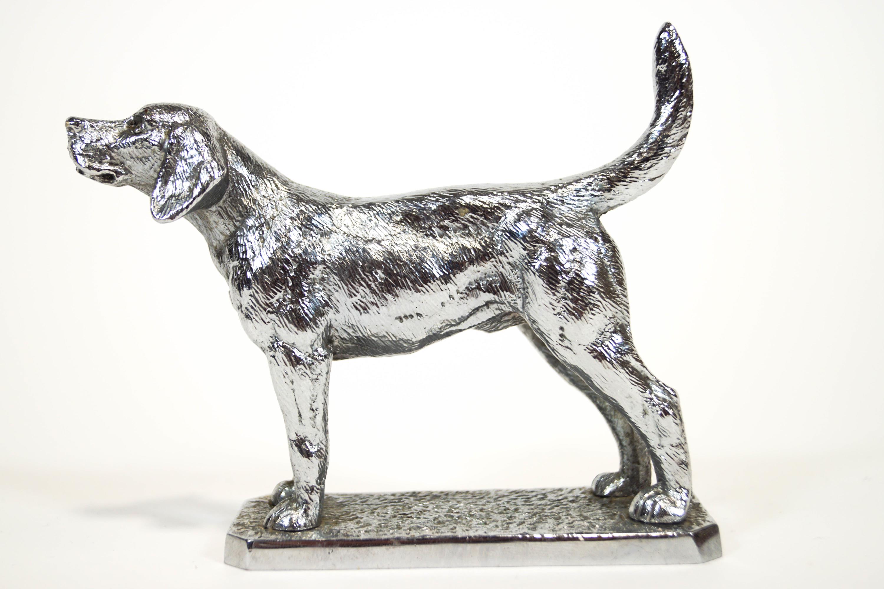 A chrome finished car mascot in the form of a fox hound,