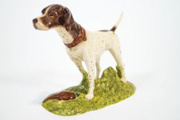 A Royal Doulton china figure of a Pointer standing on a grassy mount with a pheasant