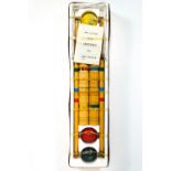 A boxed four player croquet set with wooden mallets,