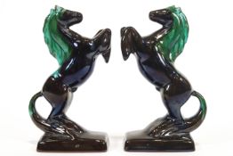 A pair of turquoise glazed Canadian Blue Mountain terracotta figures of rearing horses,