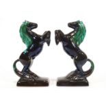 A pair of turquoise glazed Canadian Blue Mountain terracotta figures of rearing horses,