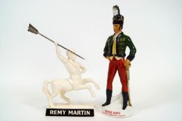 An Irish Mist china advertising figure in the form of a Hussar in red trousers and a green tunic,