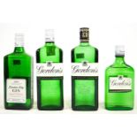 A crate of alcohol, comprising four bottles of Gordon's Gin, a bottle of Stretton's Gin...
