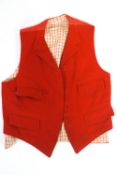 A huntsmans pink waistcoat with red chequered wool lining and four pocket,