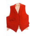 A huntsmans pink waistcoat with red chequered wool lining and four pocket,