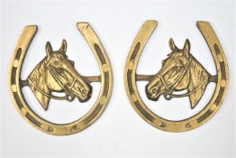 A pair of massive horse brasses depicting a bridled horse in a horse shoe frame 25 cm