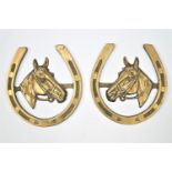 A pair of massive horse brasses depicting a bridled horse in a horse shoe frame 25 cm
