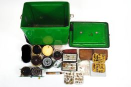 A box of fly fishing equipment including reels, fly boxes, flies wallet and live dryer