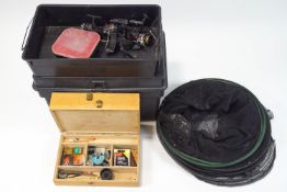 A tackle box containing floats, reels and a keep net