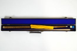 A mixed wood two part billiards cue, with the signature Ray Reardon,