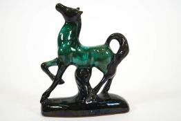 A streaked turquoise glazed Canadian Blue Mountain terracotta figure of a rearing horse, 36cm high,