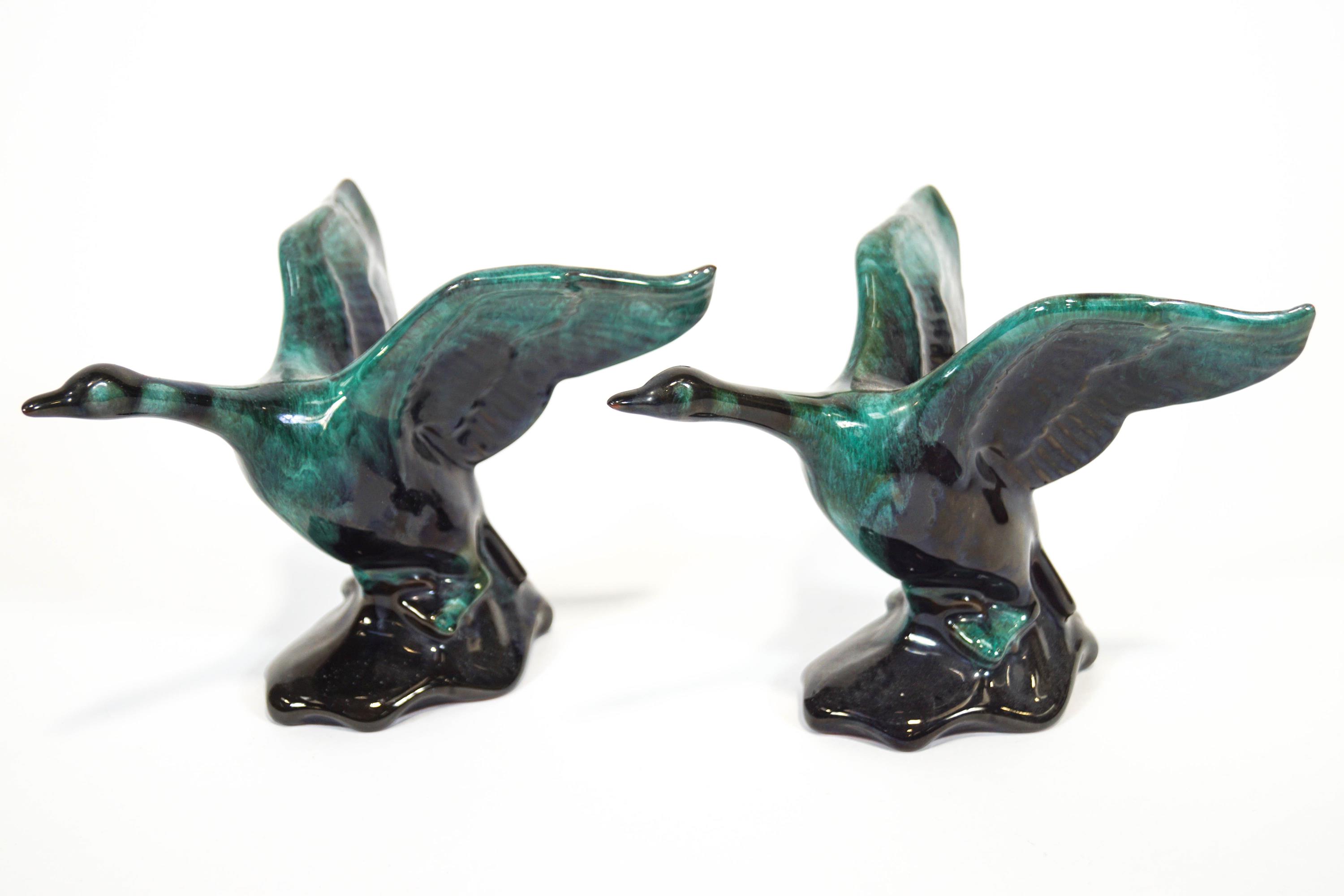 A pair of streaked turquoise glazed Canadian Blue Mountain terracotta figures of geese in flight,
