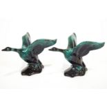 A pair of streaked turquoise glazed Canadian Blue Mountain terracotta figures of geese in flight,