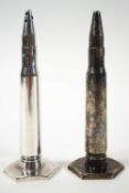 A pair of silver plated salt and pepper casters, each in the form of a bullet,