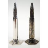 A pair of silver plated salt and pepper casters, each in the form of a bullet,