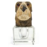 A cut glass inkwell with a hinged wooden cover in the form of a painted terrier head