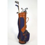 A Burton Canvas and Vinyl golf bag with an assortment of clubs and balls