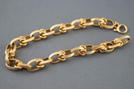 A yellow metal oval belcher and knot linked bracelet, bolt ring clasp, 190mm.