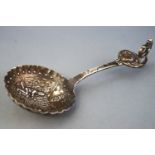 A white metal caddy spoon,