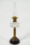 A brass oil lamp with cut glass reservoir,