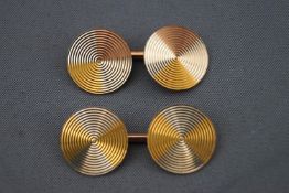 A yellow, white and rose metal pair of circular cufflinks by Deakin & Francis. Chain link fitting.