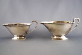 A pair of silver graduated Art Deco style sauce boats, of rounded rectangular form,