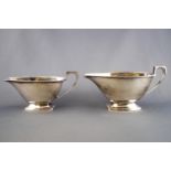 A pair of silver graduated Art Deco style sauce boats, of rounded rectangular form,