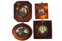 A group of four miniature style prints in an assortment of faux tortoiseshell frames,