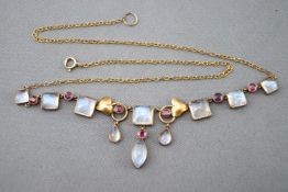 A yellow metal centrepiece necklace. Set with cabochon cut moonstones and round faceted cut rubies.