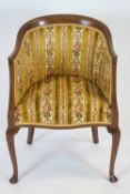 An Edwardian mahogany framed tub shaped chair, on cabriole legs,