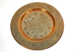 A pierced copper charger,