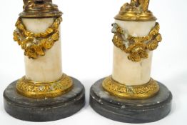 A pair of 19th century gilt metal and alabaster candlesticks in the form of putti