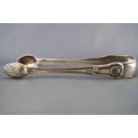 A pair of large scale silver sugar tongs, in the fiddle, thread and shell pattern,