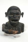 A cast iron money box in the form of a Negro,