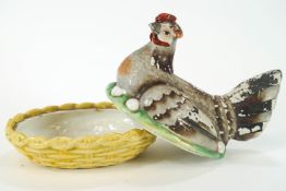 A Victorian Staffordshire pottery hen on a nest, painted in coloured enamels,