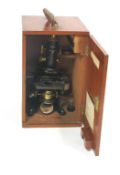 A microscope by Watson & Sons, No 58101, in a blackened metal finish,