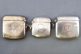 A group of three squared form silver vestas, two highlighted with engine turned decoration,