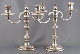 A pair of loaded silver George III style candlesticks with detachable two branch candelabra