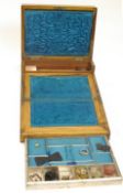 A Victorian walnut sewing/writing box, opening in two sections, the top with brass inlaid crest,