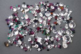 A mixed lot of loose gemstones of varying sizes, cuts and weight.