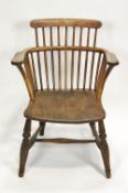 A 19th century ash and elm Windsor chair with turned legs linked by an H stretcher,