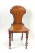 A Victorian mahogany hall chair with shaped shield back,